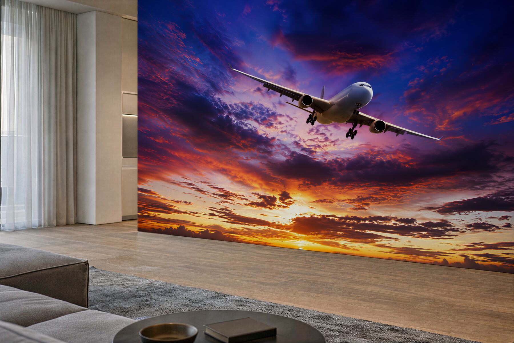 Papier peint avion volant devant un ciel de coucher de soleil